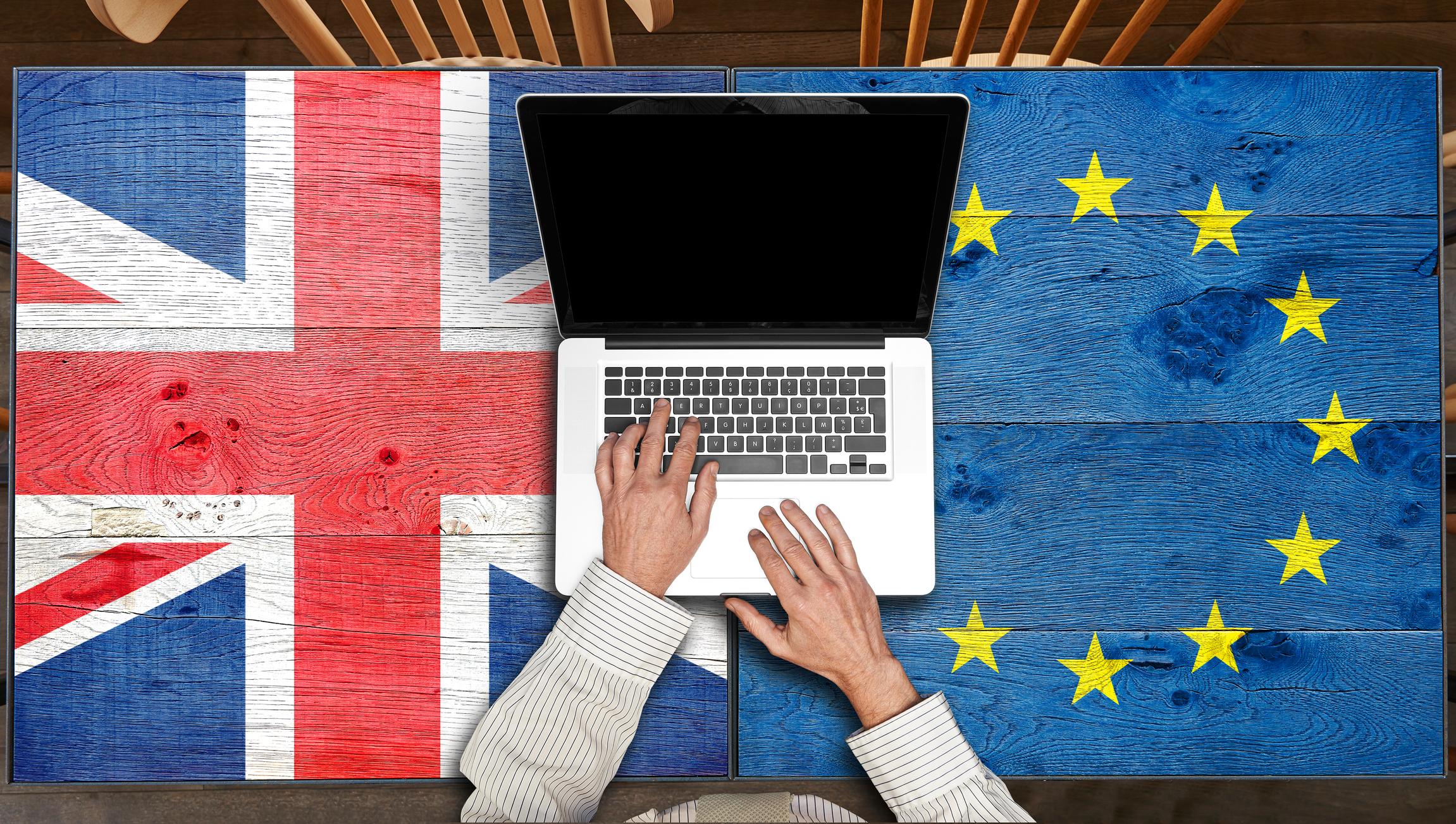European and UK flagged wooden tables with laptop