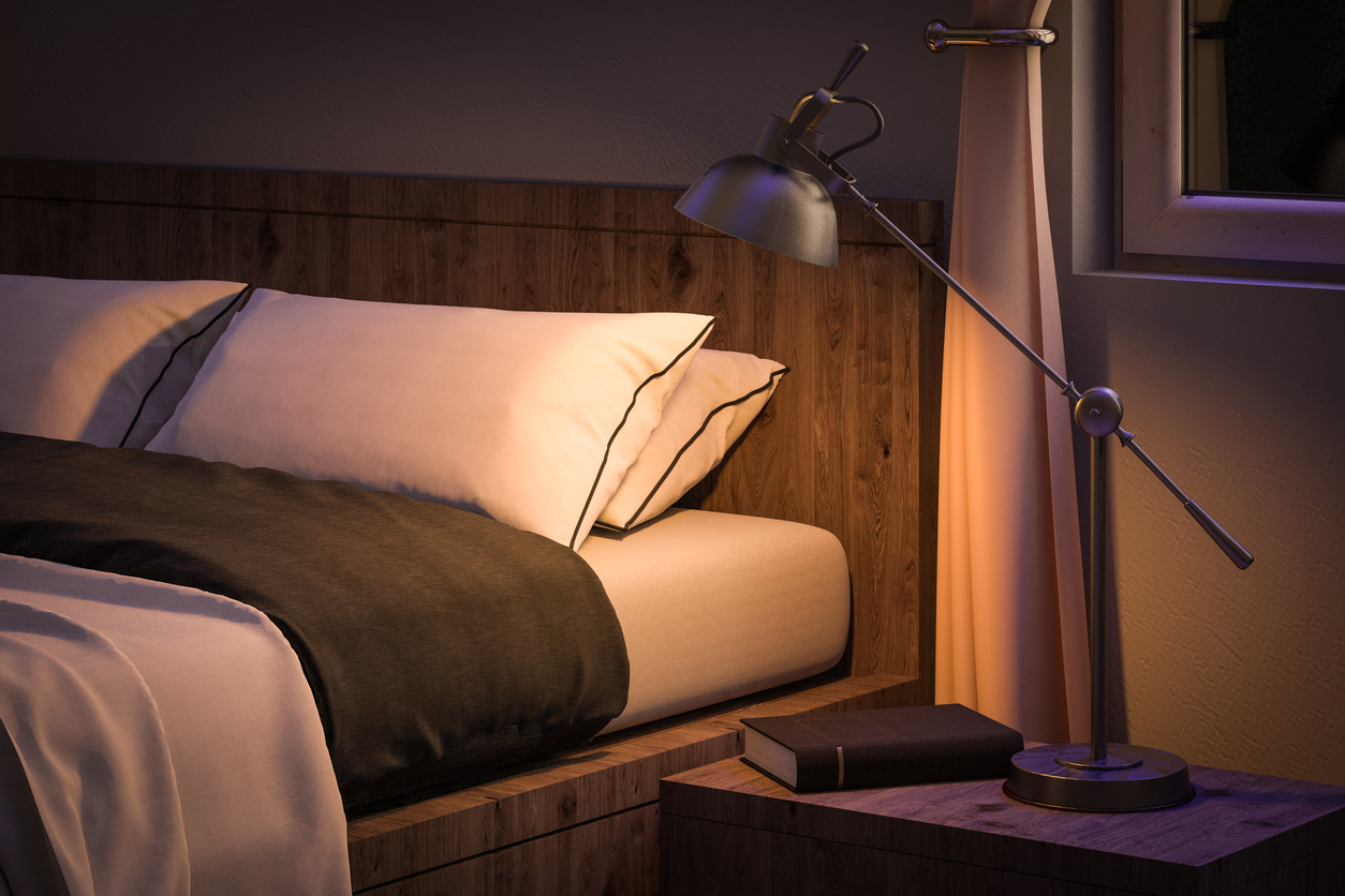 bedroom interior with book and reading lamp