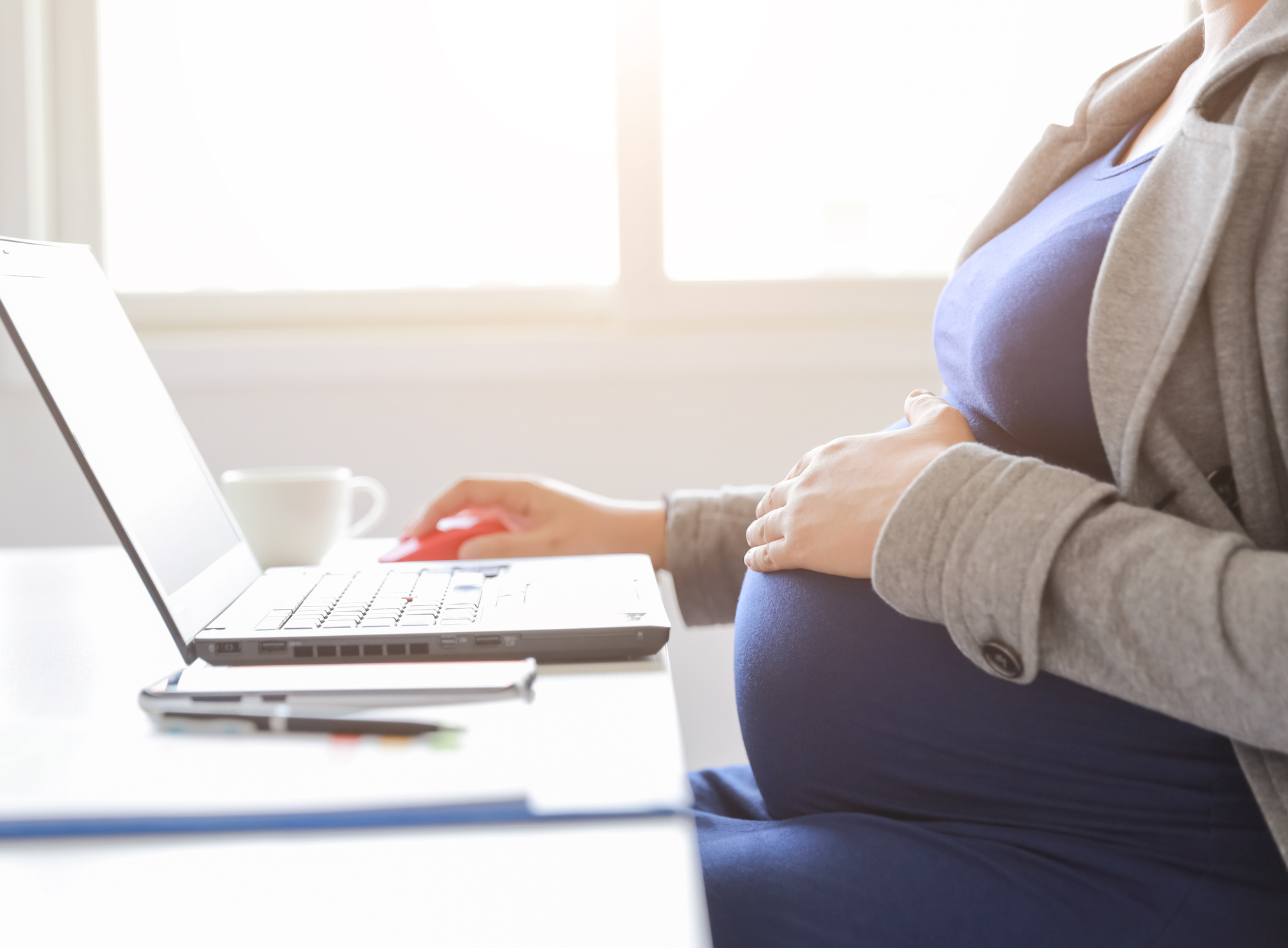 Pregnant lady working at laptop